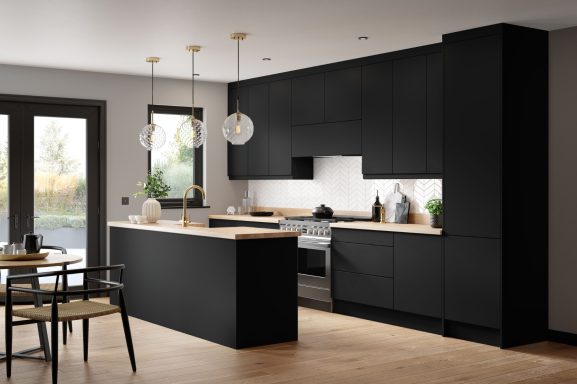 Modern black kitchen with wooden countertop, pendant lights, and open dining area.